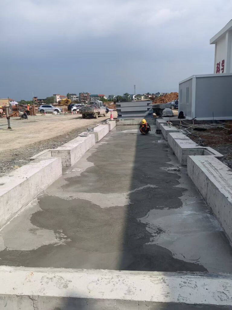 Reinforced concrete foundation slab and load cell base plate positioning for 3m x 18m truck scale
