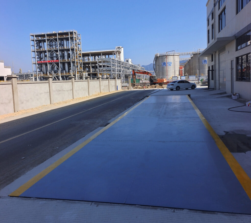 Heavy duty electronic truck scale installed at an industrial site for vehicle and cargo weighing