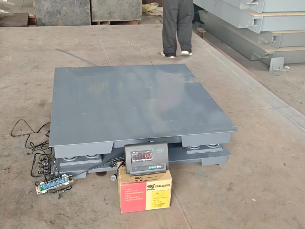 Close up of a heavy duty industrial floor scale showing the robust base and thickened steel deck
