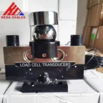 Front photo of the HM9B 30 ton analog load cell showing the spherical load-bearing assembly and mounting base