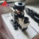 Angled photo of the HM9B 30 ton analog load cell showing the load-bearing assembly, mounting holes and signal cable