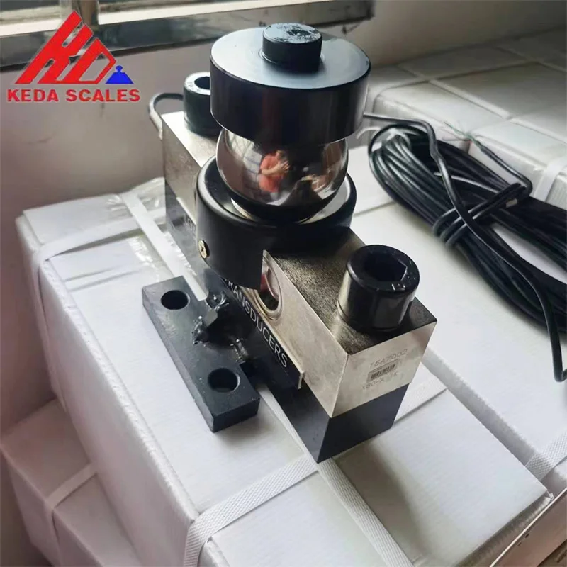 Angled photo of the HM9B 30 ton analog load cell showing the load-bearing assembly, mounting holes and signal cable